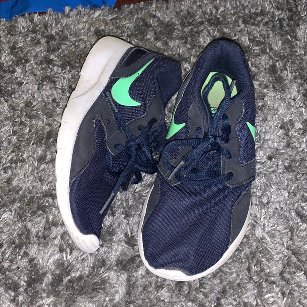 Two pair of Nike boys shoes.